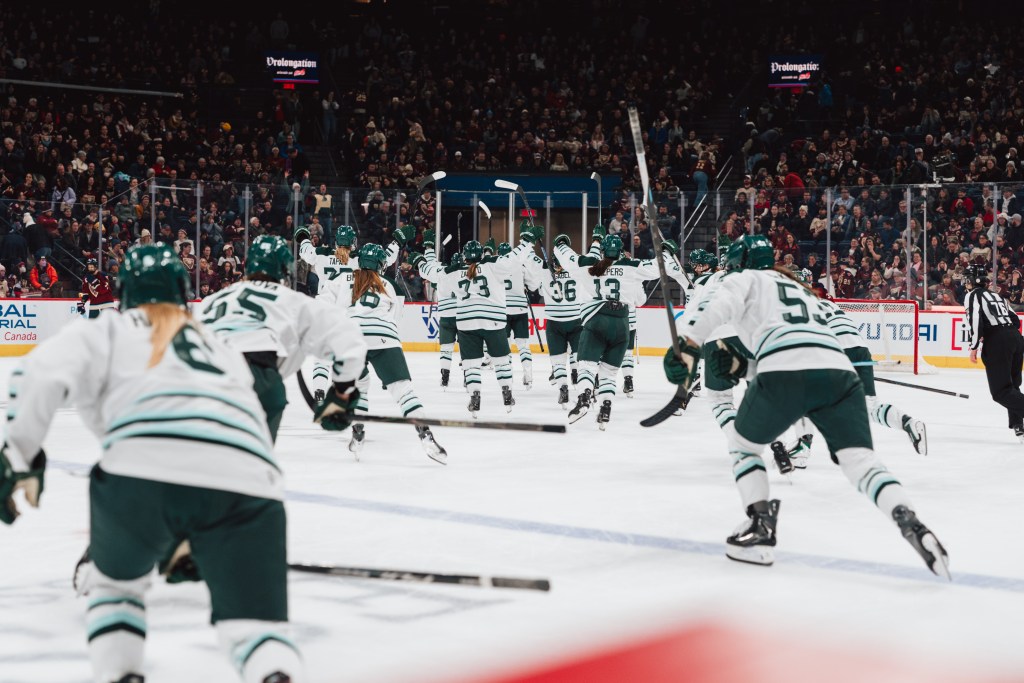 The Fleet pour off the bench to celebrate their win. They are wearing white away uniforms.