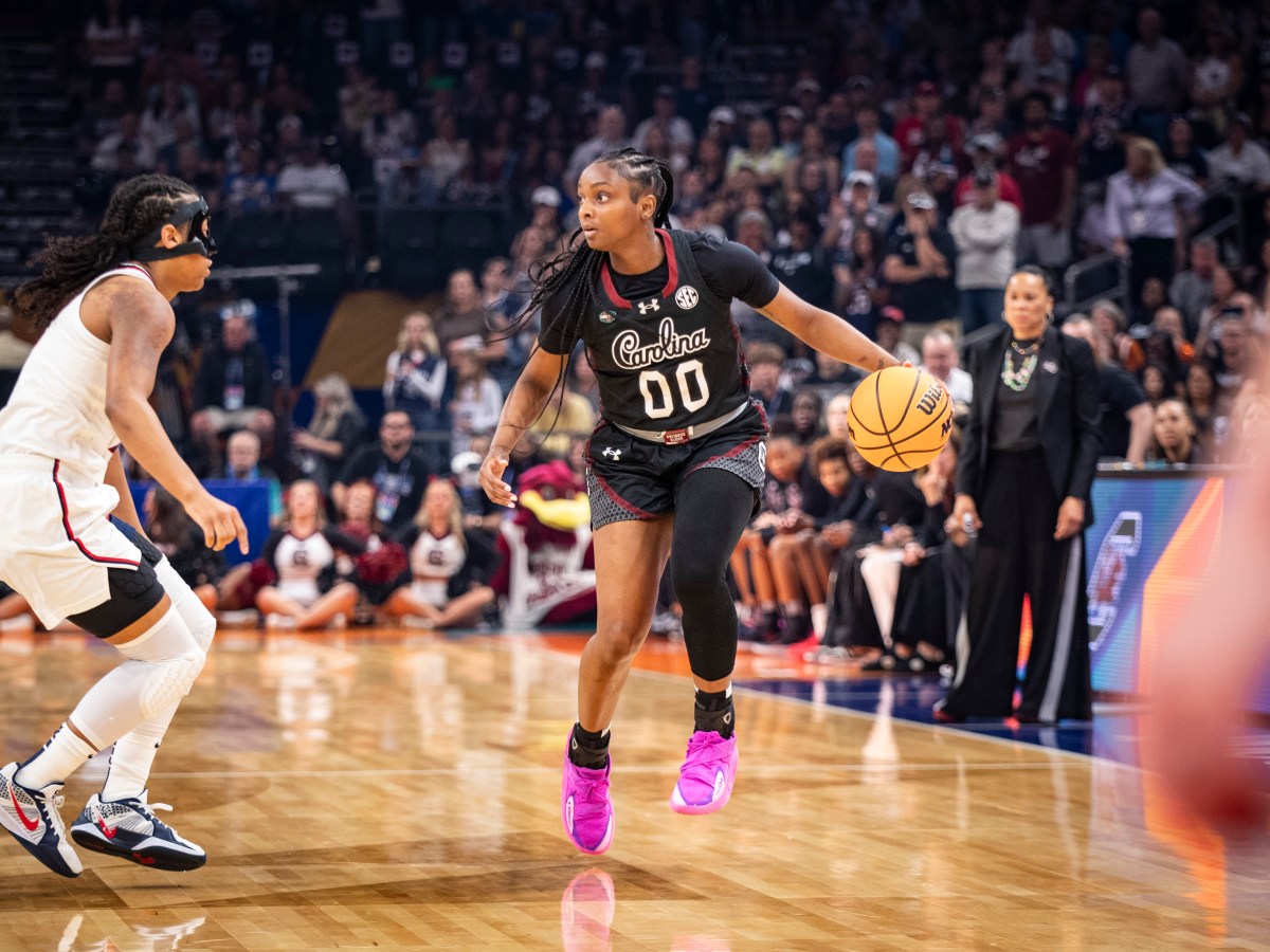South Carolina guard Ta'Niya Latson dribbles the ball with her left hand on the perimeter as UConn guard KK Arnold moves her feet to try to stay with her.
