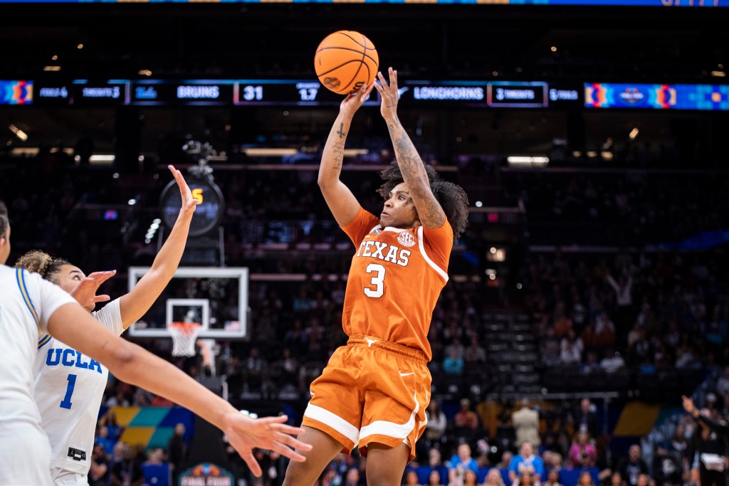 Texas guard Rori Harmon shoots a fadeaway jumper with her right hand as a UCLA defender tries to close out on her.