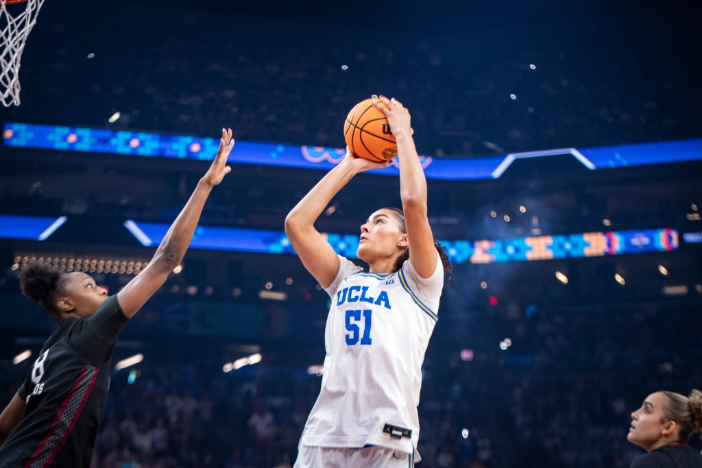 Lauren Betts shoots over a defender's outstretched arm.