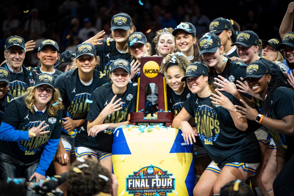 The UCLA team poses for a photo with the NCAA champions trophy after beating South Carolina in the national championship game at Mortgage Matchup Center in Phoenix, Ariz., on April 5, 2026. (Photo credit: Domenic Allegra | The IX Sports)