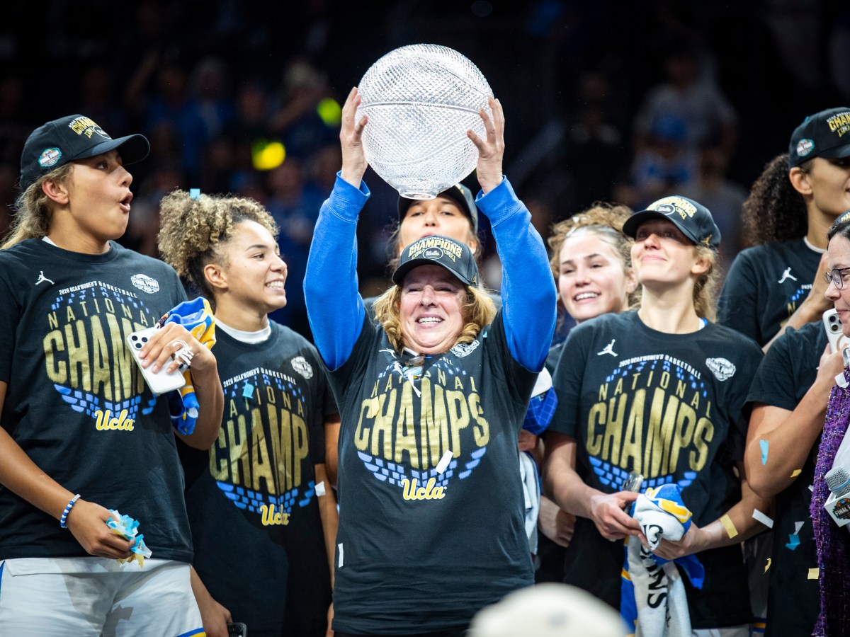UCLA coach Cori Close lifts up a trophy after the Bruins beat South Carolina in the national championship game at Mortgage Matchup Center in Phoenix, Ariz., on April 5, 2026. (Photo credit: Domenic Allegra | The IX Sports)