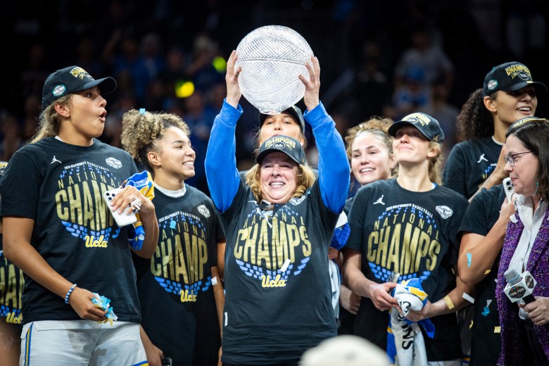 UCLA coach Cori Close lifts up a trophy after the Bruins beat South Carolina in the national championship game at Mortgage Matchup Center in Phoenix, Ariz., on April 5, 2026. (Photo credit: Domenic Allegra | The IX Sports)