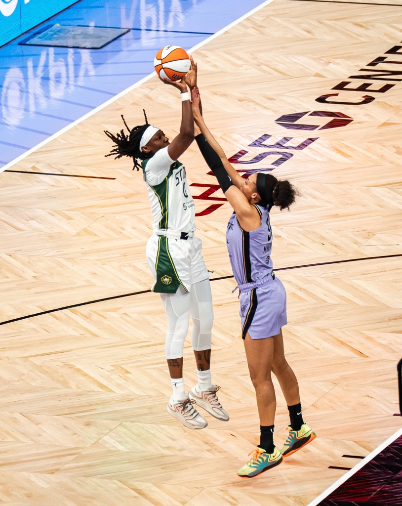 Rennia Davis floats a foot or two in the air just as she releases her shot over the outstretched arms of a Valkyries player.