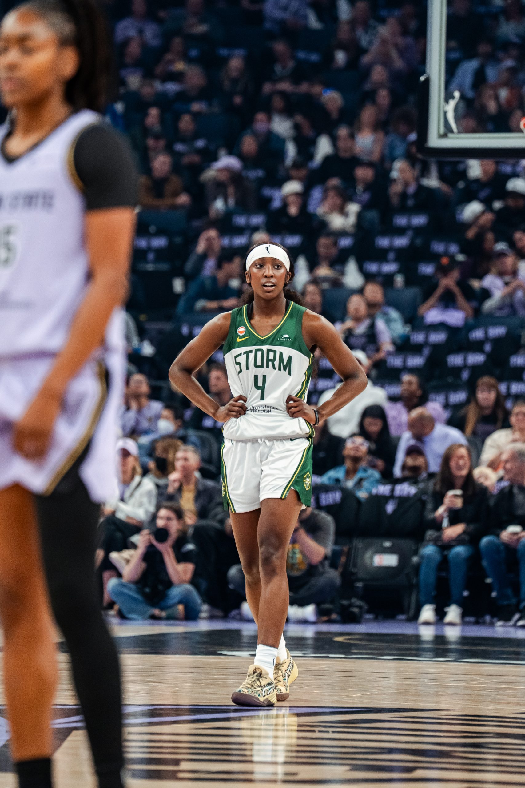 Seattle Storm guard Flau'jae Johnson stands on the Chase Center court during the preseason game against the Golden State Valkyries with her hands on her hips.