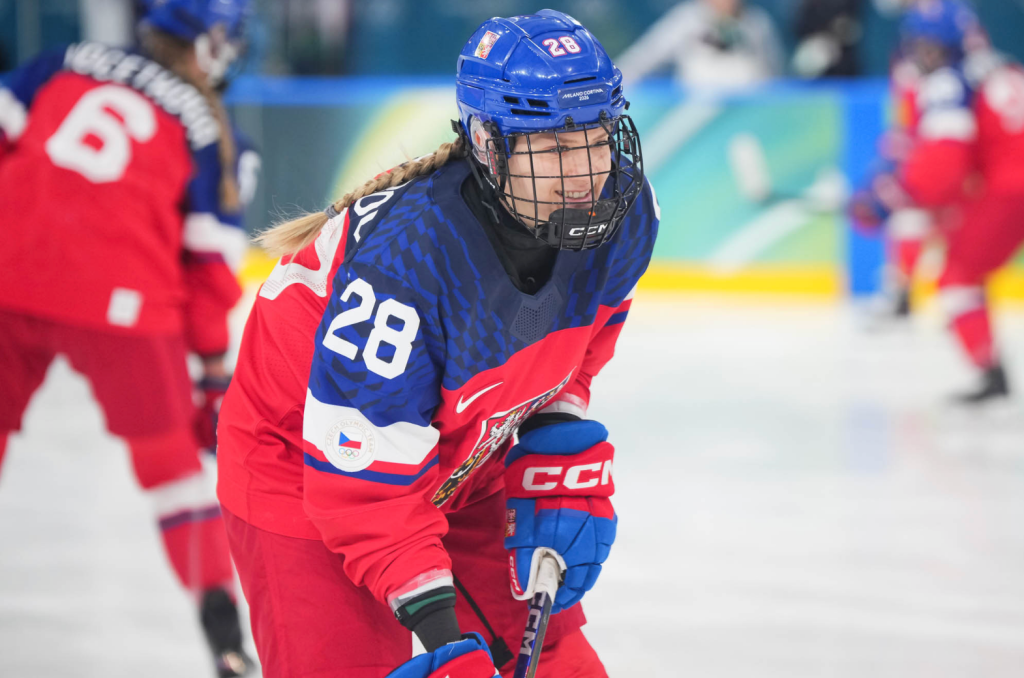 Neubauerová smiles as she looks at something out of frame. She is wearing a red home Czechia uniform.