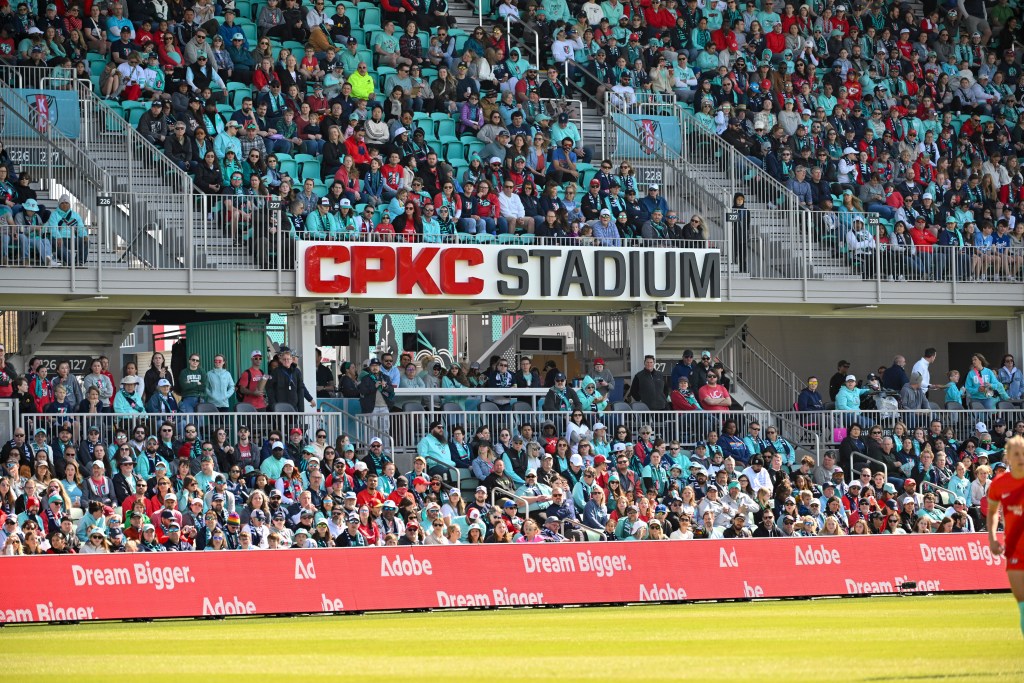 A crowded stadium surrounds the red and black letters spelling out CPKC Stadium