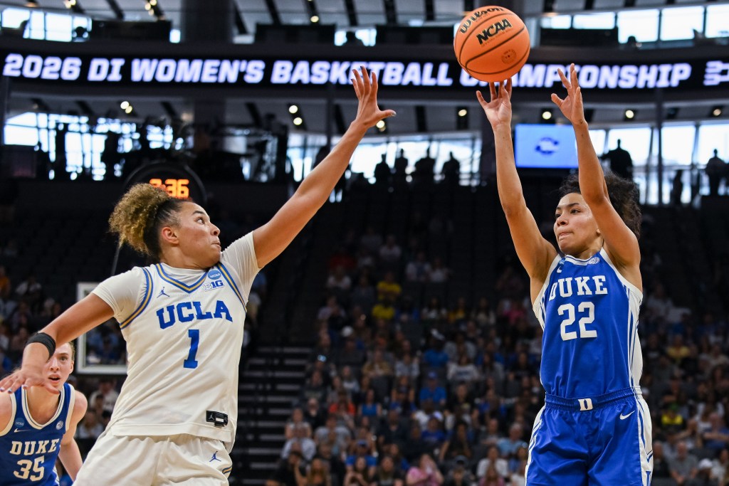 Duke guard Taina Mair shoots over UCLA guard Kiki Rice who is closing out with her hand up but not reaching the ball as it leaves Mair's hands.