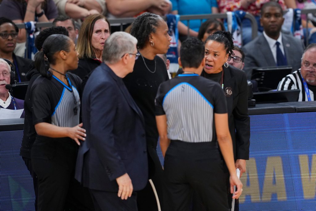 UConn head coach Geno Auriemma and South Carolina head coach Dawn Staley get in a verbal altercation while surrounded by their assistant coaches and the referees.