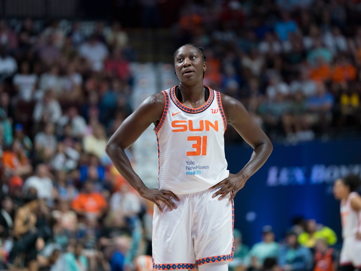 Connecticut Sun center Tina Charles (31) stands with her hands on her hips in front of a blurred crowd in the background