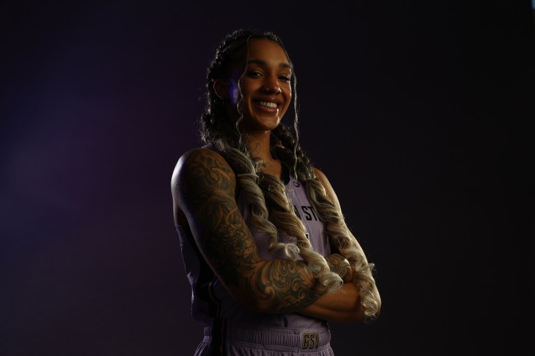 Gabby Williams, arms crossed.