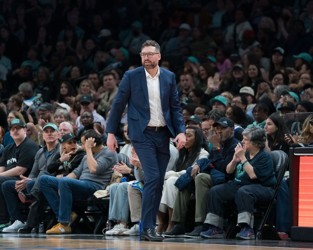 New York Liberty head coach Chris DeMarco walks the sidelines during the Liberty's home opener in a blue suit.