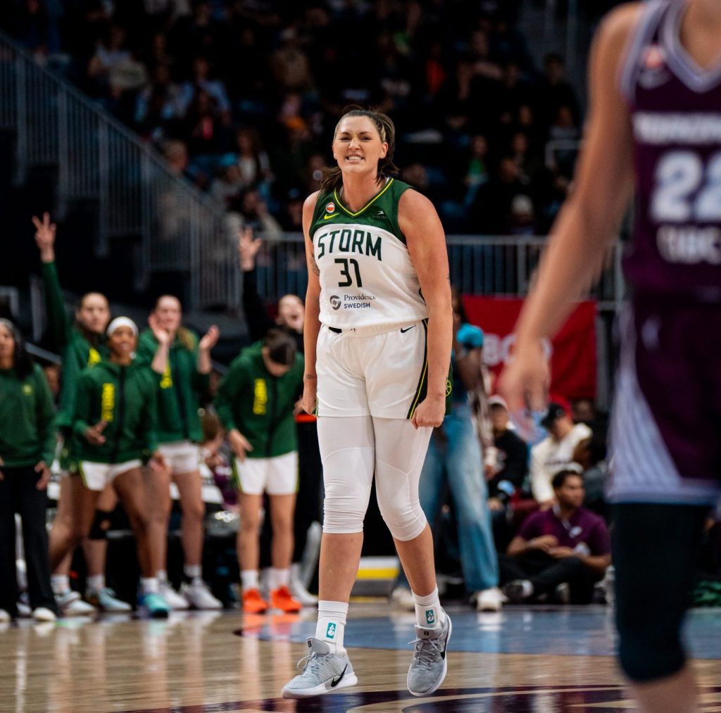 Stefanie Dolson grimaces in excitement and balls her fists at her sides as she walks backwards down the court.
