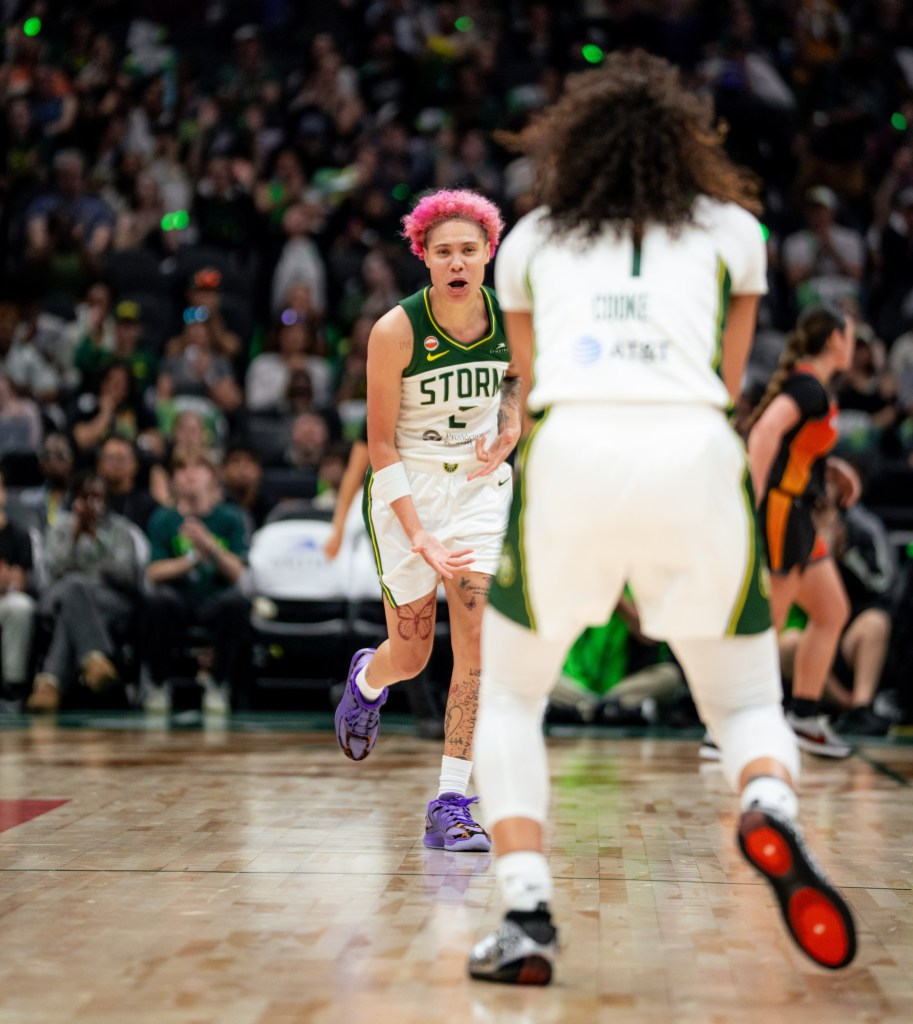 Natisha Hiedeman and Zia Cooke run towards each other yelling and celebrating after a made basket.