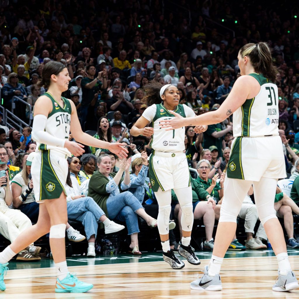 Seattle Storm guards Jade Melbourne and Zia Cooke go to low five center Stef Dolson.