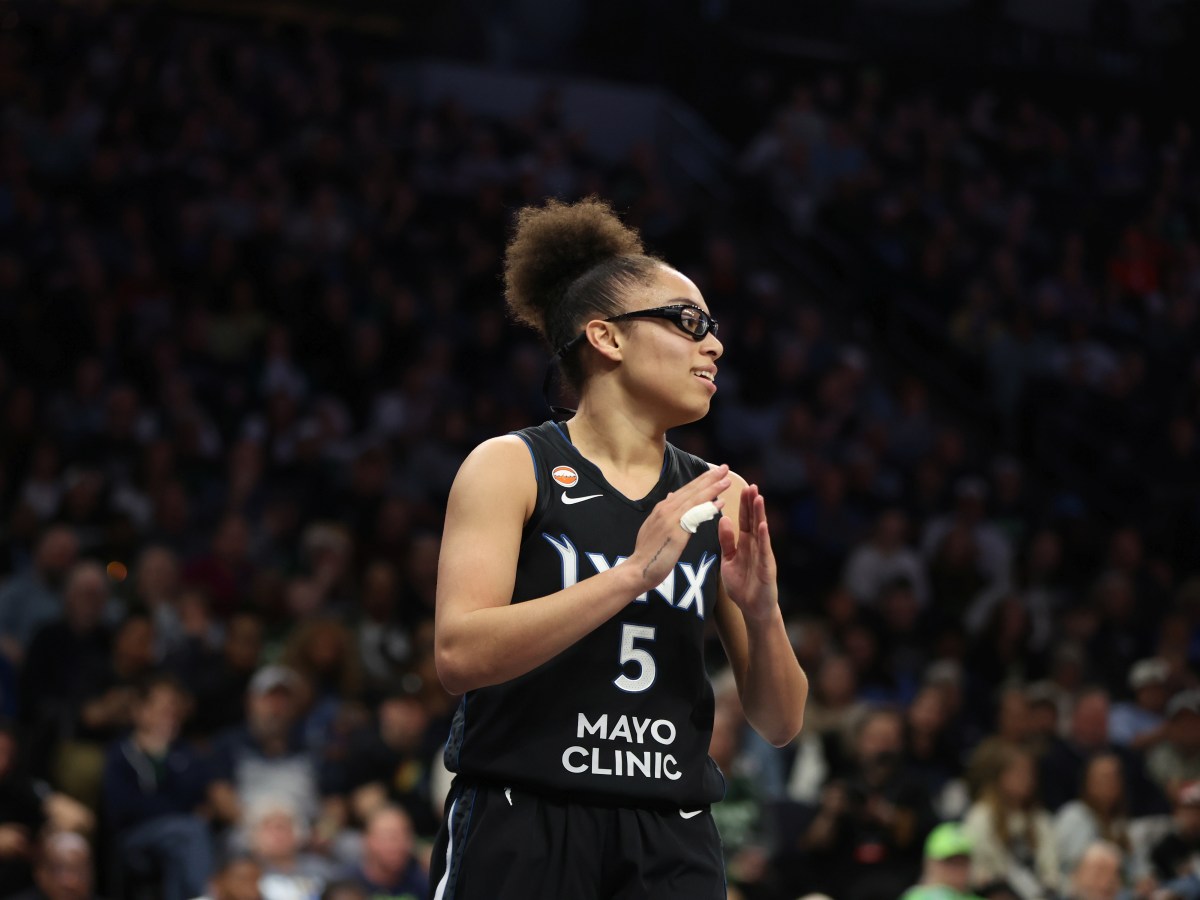 Olivia Miles claps her hands and smiles during her first WNBA game