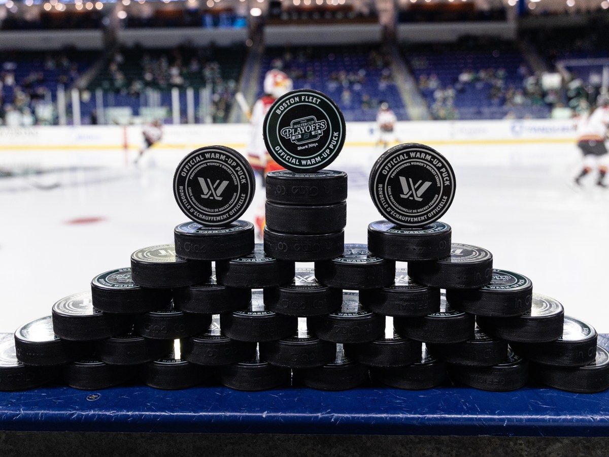 Pucks stacked before a PWHL hockey game.
