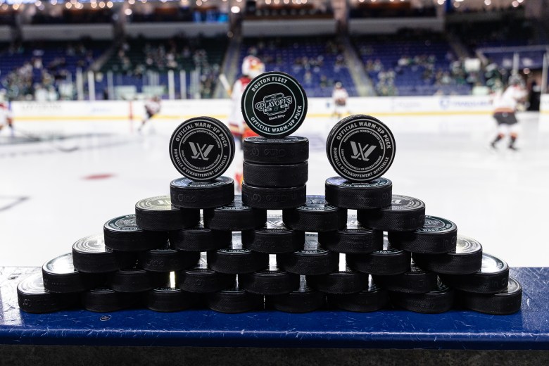 Pucks stacked before a PWHL hockey game.