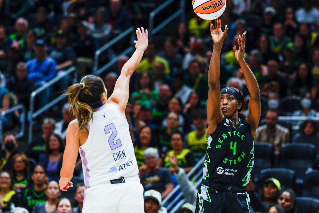 Seattle Storm guard Flau'jae Johnson releases a 3-point shot over Valkyries guard Kaitlyn Chen who is closing out on her with a hand out.