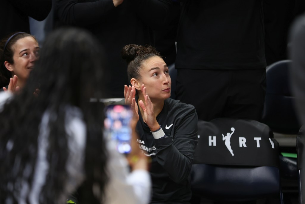 Jessica Shepard clapping on the bench