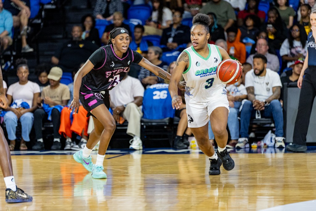 Diamond Johnson is being defended by a player wearing a black uniform.