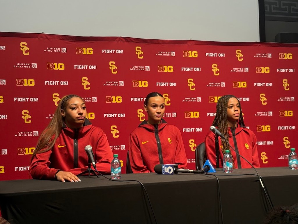 Jazzy Davidson, Kennedy Smith and Saniyah Hall look onward as they speak to the media. 