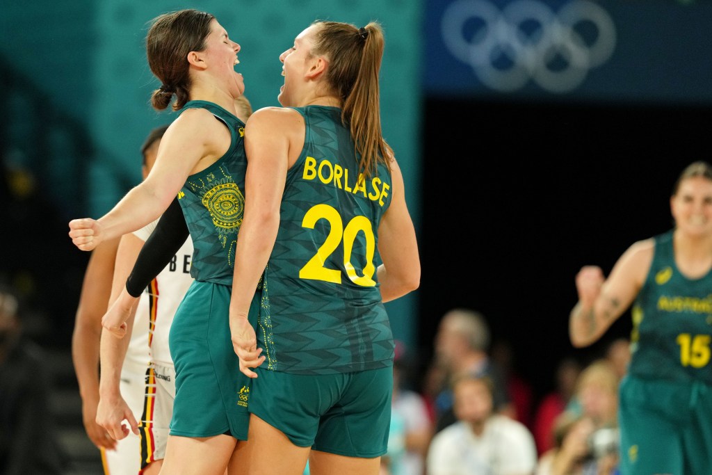Australia guards Jade Melbourne and Isobel Borlase chest-bump and yell in celebration during a game.