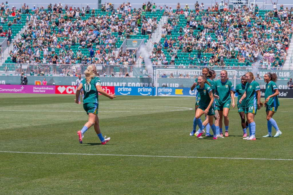 Denver Summit FC player Lindsey Heaps (10) runs in for an embrace with teammate <a rel=