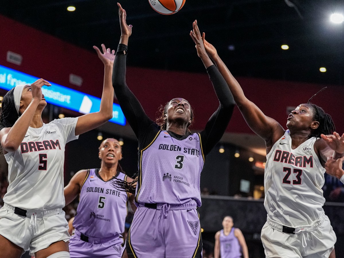Laeticia Amihere battles for a rebound against Atlanta's Sika Kone and Angel Reese.