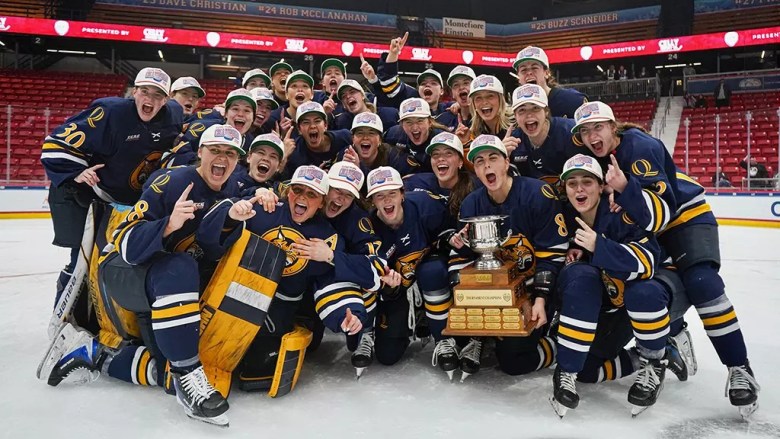 Quinnipiac players celebrate after winning the ECAC women’s hockey conference championship.