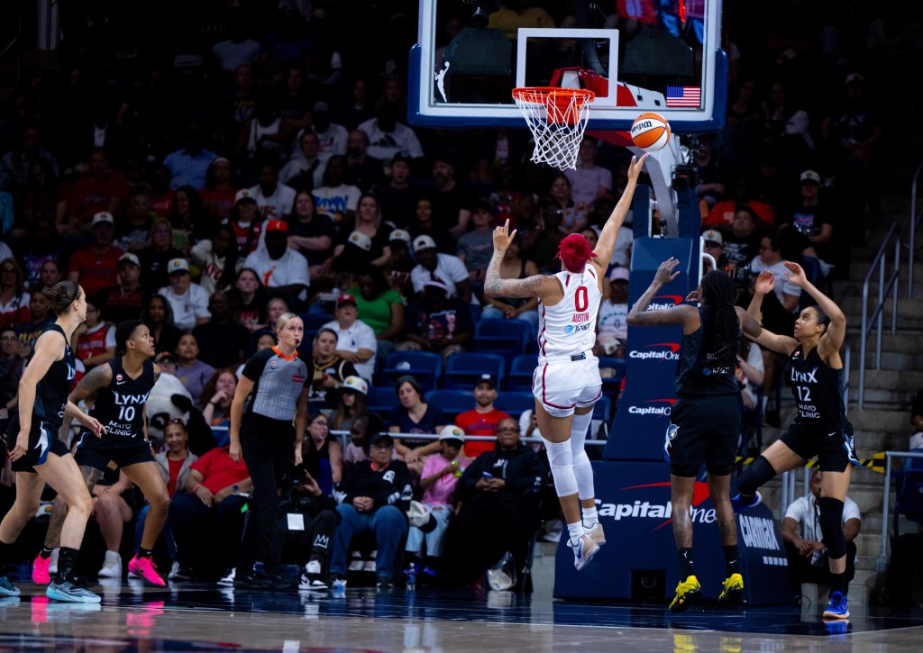 Washington Mystics center Shakira Austin is shown with her back to the camera, shooting a wide-open right-handed layup.