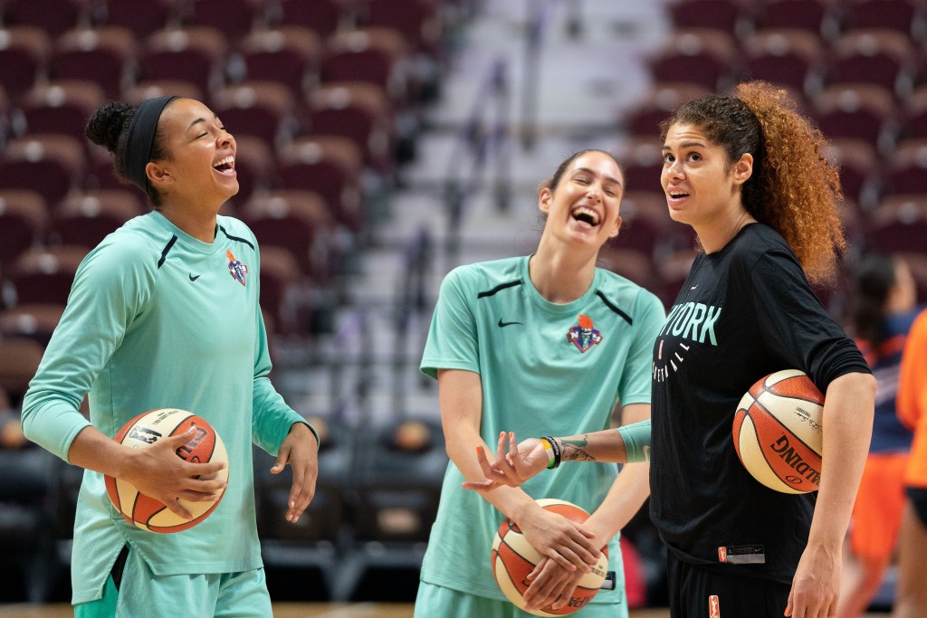 Rebecca Allen is smiling and laughing with New York Liberty teammates from 2018