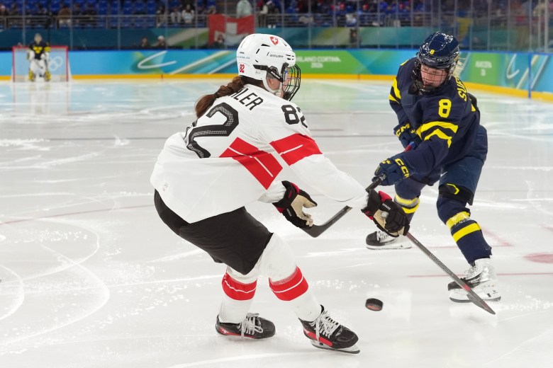 Alessia Baechler of Switzerland and Hilda Svenssonof Sweden battle for the puck.