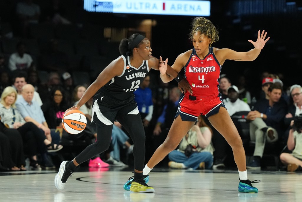 Washington Mystics guard/forward Betnijah Laney-Hamilton slides her feet laterally and has her left hand up as she plays defense. Las Vegas Aces guard Chelsea Gray dribbles with her right hand and uses her left arm to fend off Laney-Hamilton.