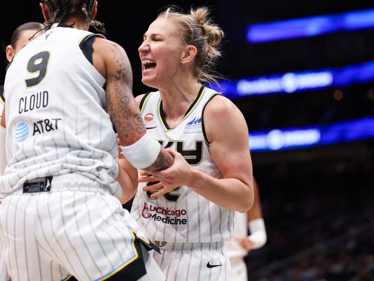 Chicago Sky guards Courtney Vandersloot and Natasha Cloud celebrate a play. Vandersloot is in the center of the frame, grabbing Cloud's arm, while Cloud off to the left.