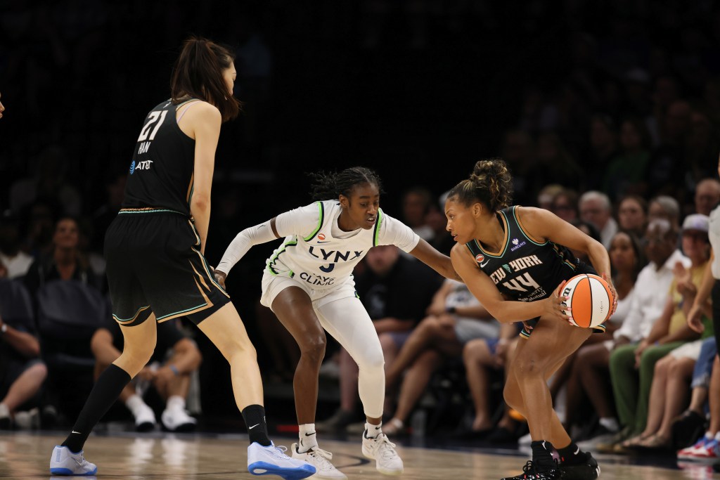 Betnijah Laney Hamilton has the ball while being guarded by player on the Minnesota Lynx