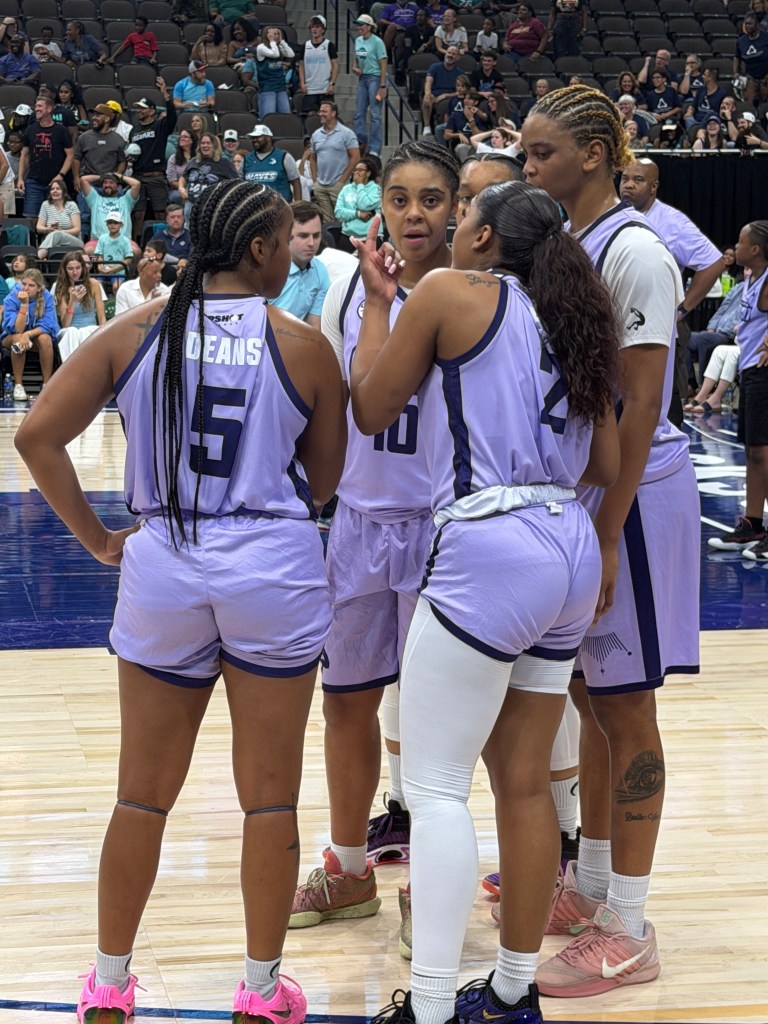 A group huddle for the Charlotte Crown.
