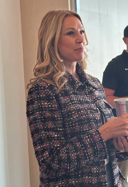 A photo of Portland Fire and Portland Thorns owner Lisa Bhathal Merage holding a metal cup