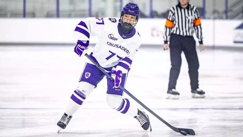 Naemi Herzig plays the puck at home for Holy Cross