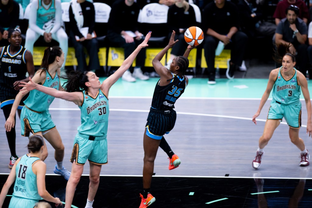 Breanna Stewart closes out on Sky forward Aicha Coulibaly's shot while Rebecca Allen, Han Xu and Pauline Astier defend around her.