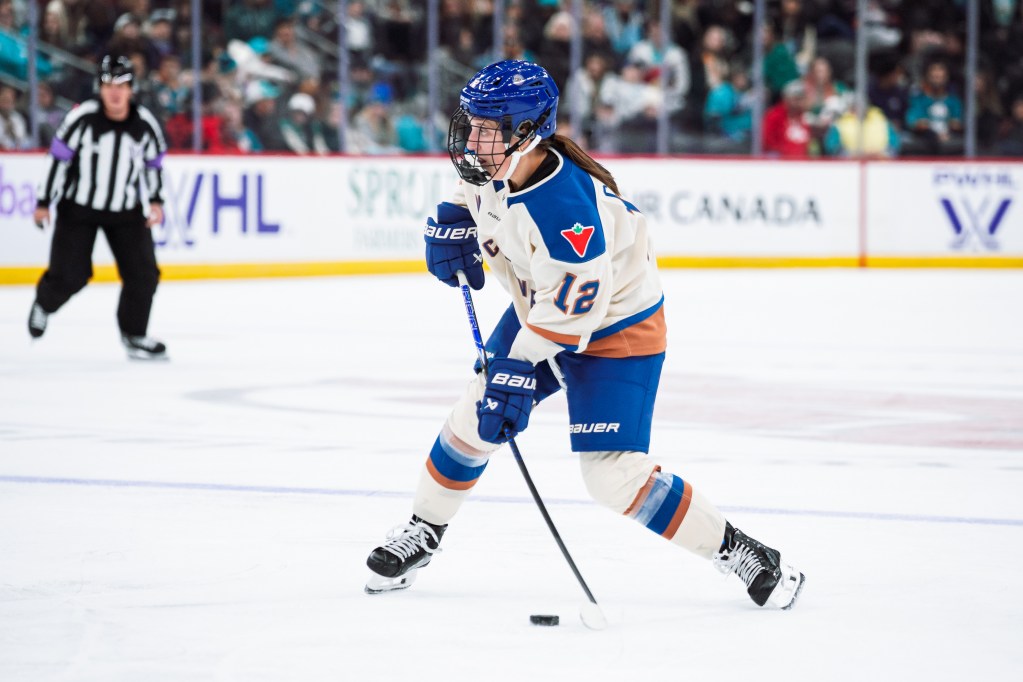 Jenn Gardiner handles the puck for the Vancouver Goldeneyes.