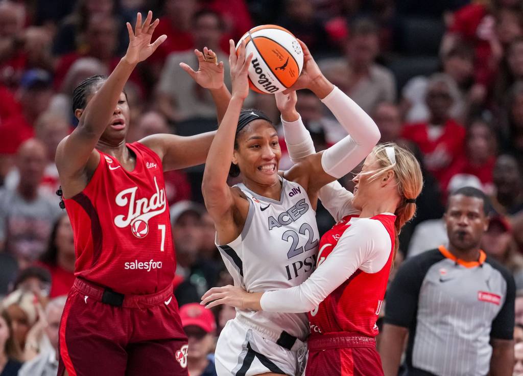 Las Vegas Aces center A'ja Wilson (22) passes the ball against Indiana Fever guard Sophie Cunningham (8) on Thursday, Aug. 6,