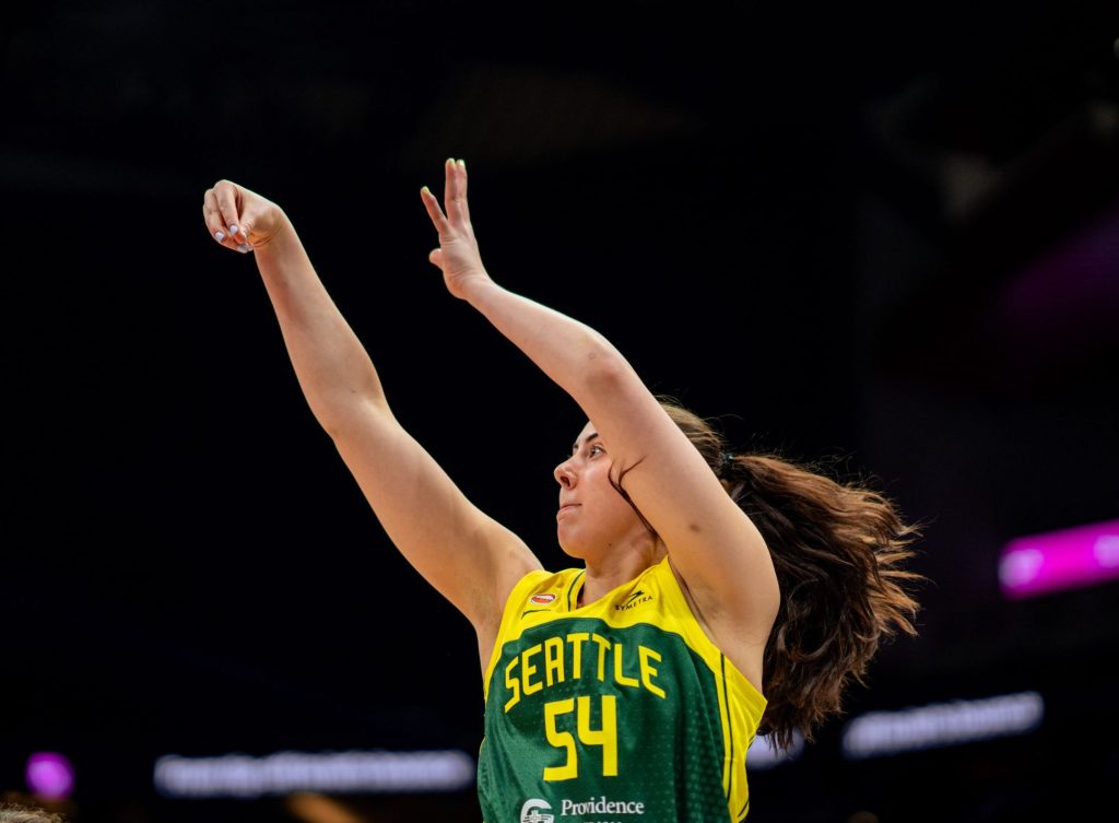 Mackenzie Holmes has her arms raised having just released a shot.