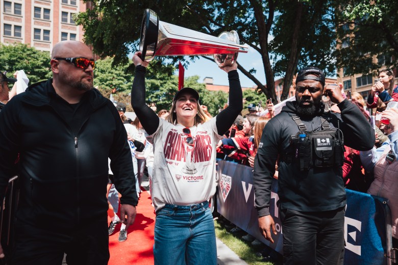 Marie-Philip Poulin raises the Walter Cup at the Montréal Victoire parade in 2026.