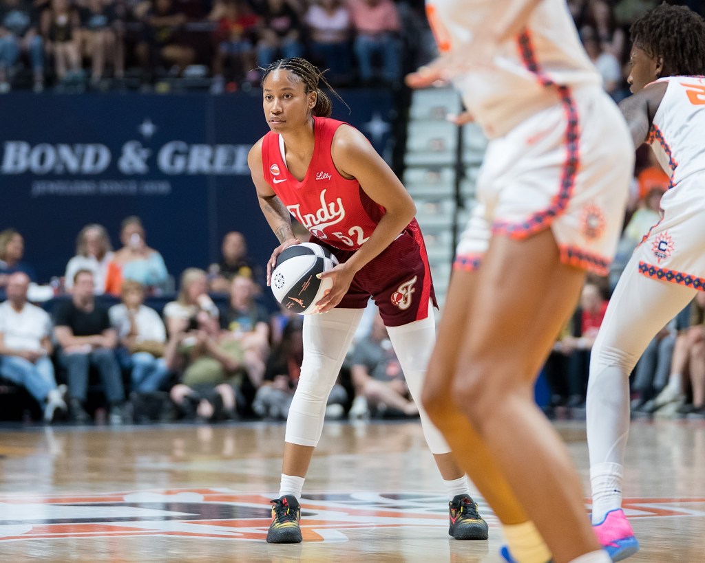 Indiana Fever guard Ty Harris makes a pass against the Connecticut Sun