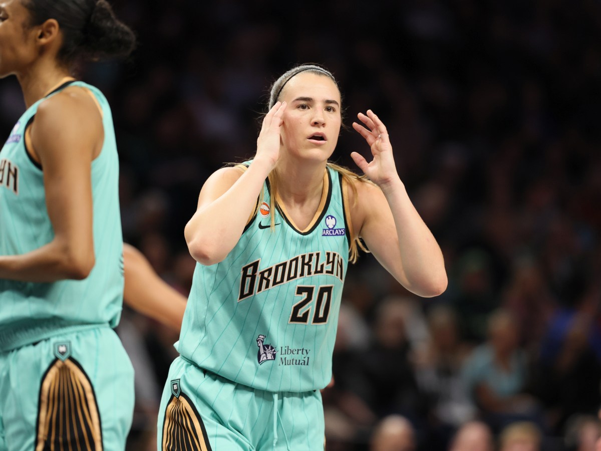 Sabrina Ionescu looks surprised with her hands near her head