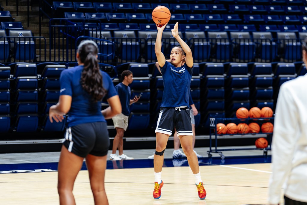 Kejia Ran goes up for a shot in practice. She wears a blue shirt and black shorts.