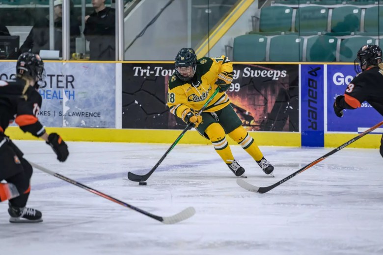 Raedyn Spademan controls the puck at the blueline in Clarkson's yellow jerseys