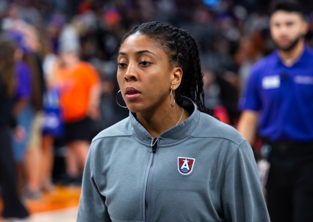 Camryn Brown, an assistant coach for the Atlanta Dream, wears a gray sweatshirt before a game against the Phoenix Mercury