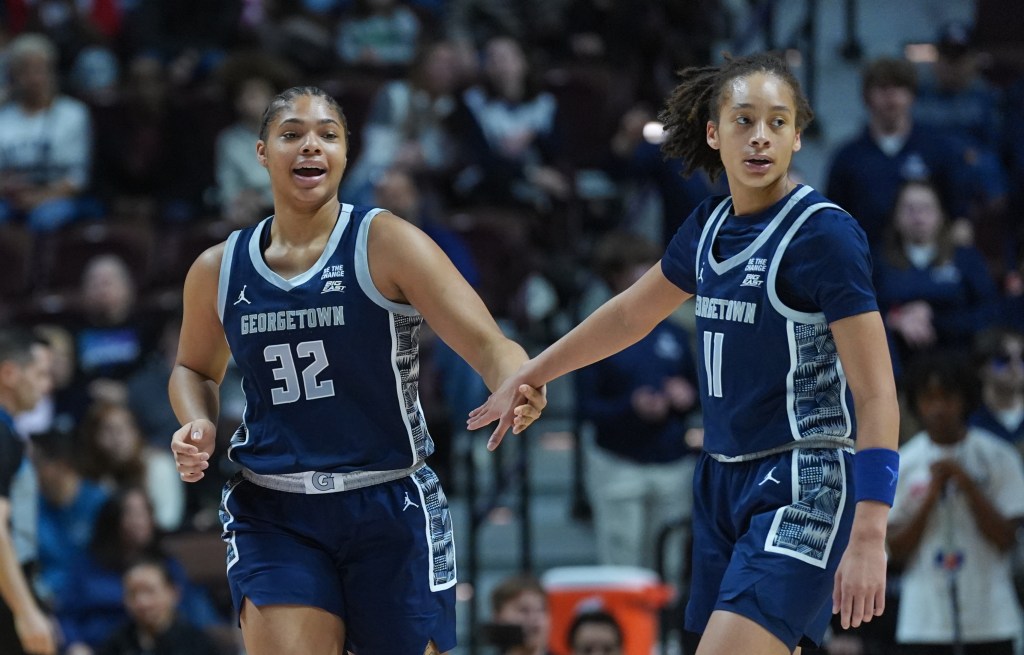 Georgetown teammates Byars and Miller no-look high-five getting back on defense mid-game.